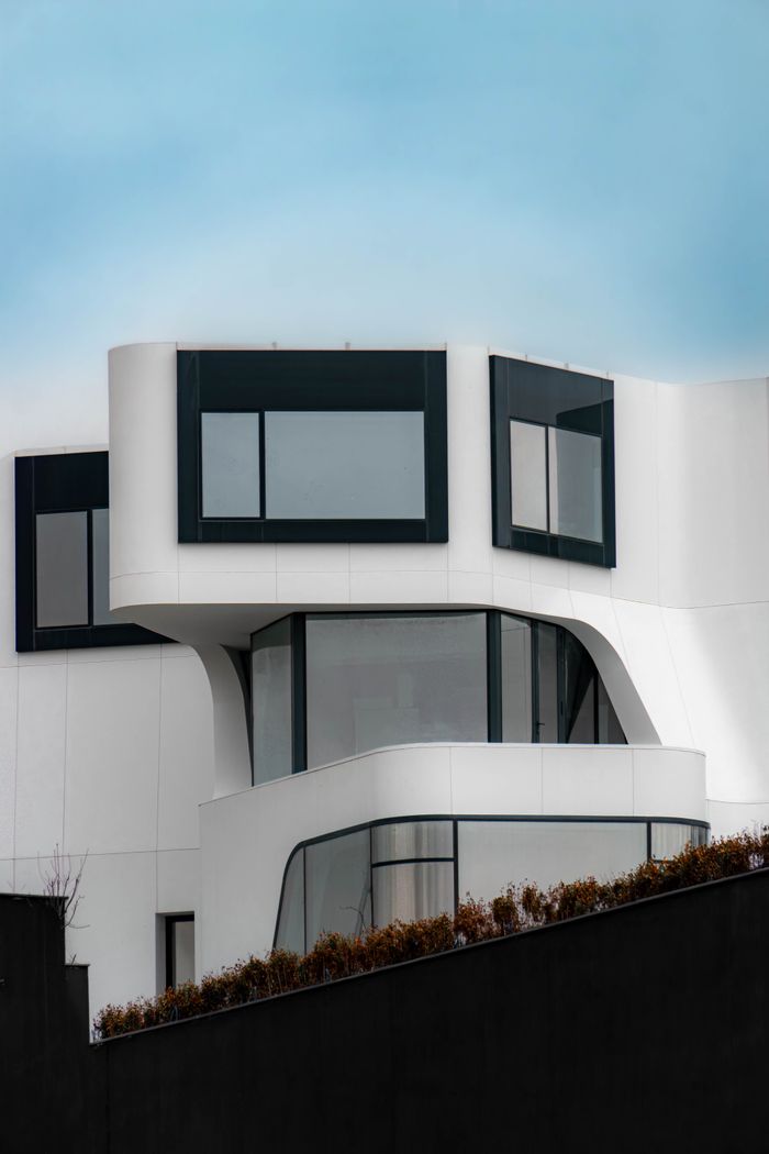 Services Stunning modern architectural design of a building in Ankara, featuring sleek curves and large windows.